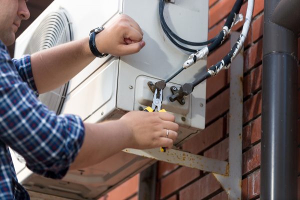 closeup-of-male-technician-repairing-outdoor-air-conditioner-unit.jpg closeup-of-male-technician-repairing-outdoor-air-conditioner-unit.jpg