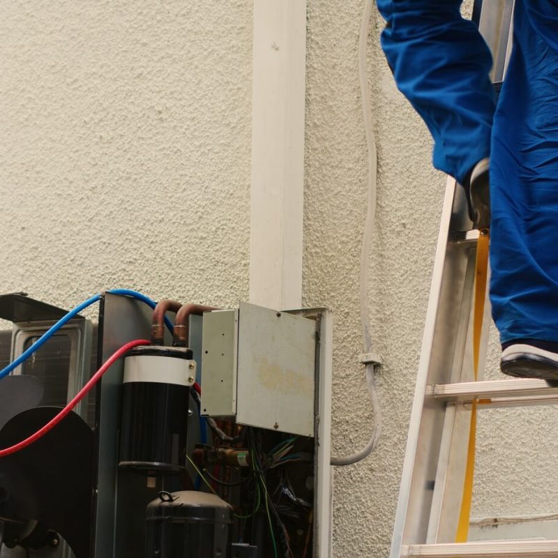 Coworkers checking HVAC system