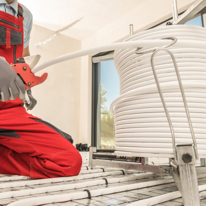 HVAC Worker Cutting Radiant Floor Heating Pipeline Using Tube Slicer