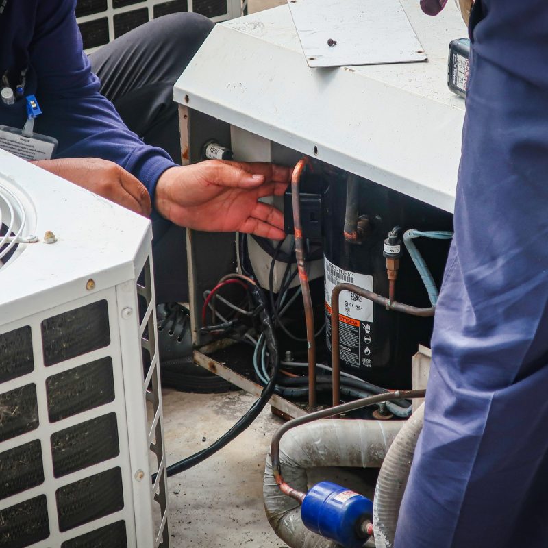Maintenance man repair air conditional and air compressor of the factory.